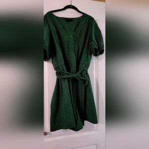 Green eyelet puff sleeve shorts romper from Lane Bryant.